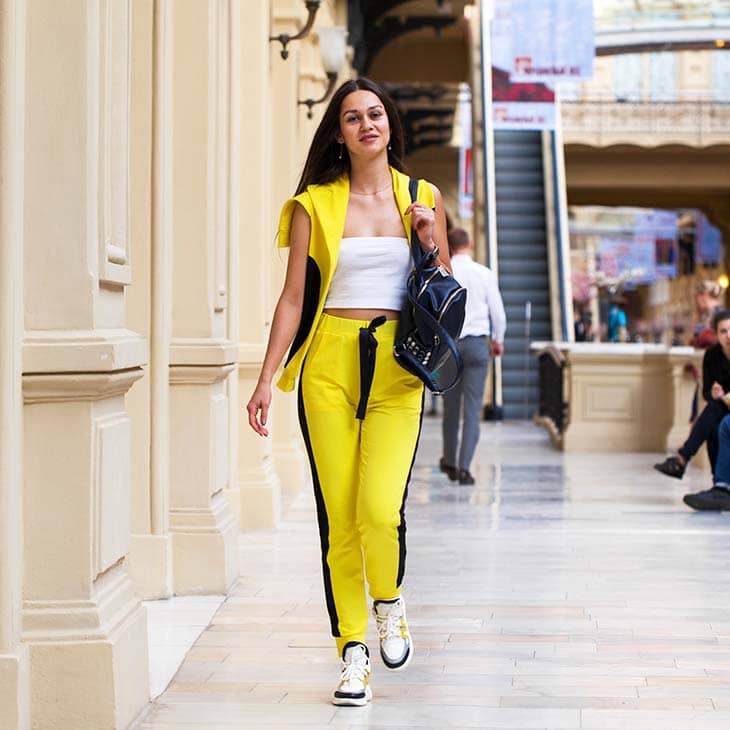 Woman walking shopping mall yellow tracksuit