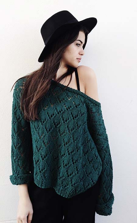 Woman looks side hat sweater