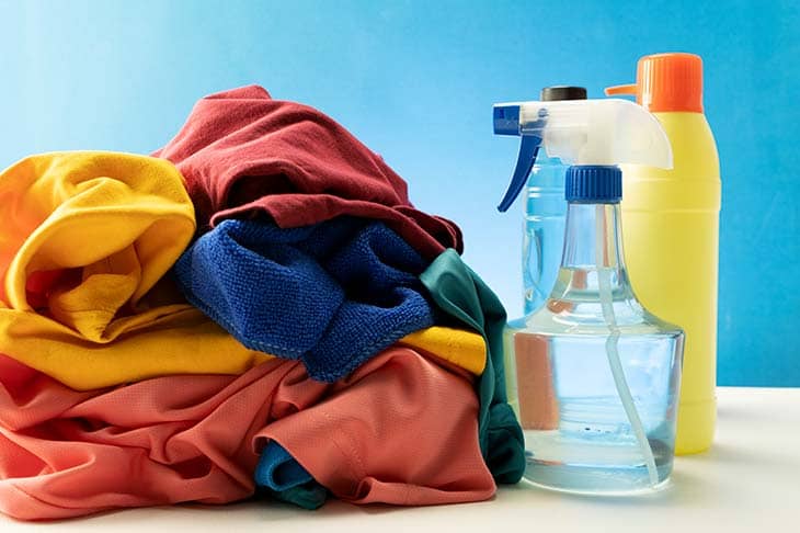 Bottles cleaning products pile clothes table
