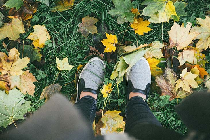 Woman feet slip on grass leafs