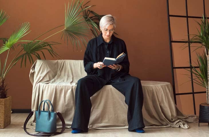 Woman reading book dark outfit