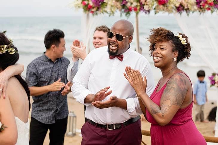 Guests at a beach wedding ceremony