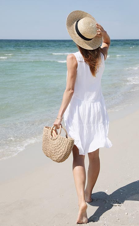Woman walking beach sundress