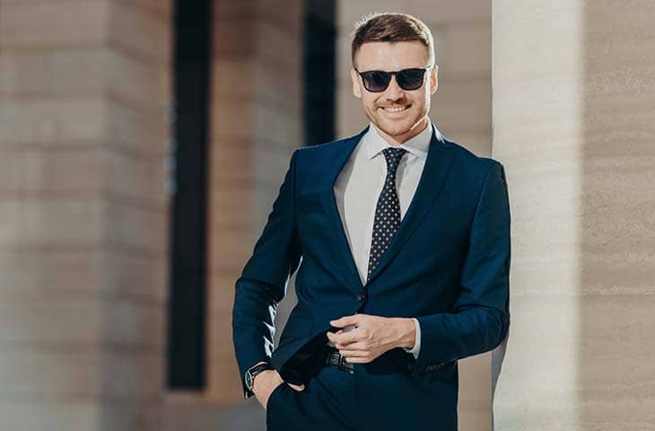 Man smiling sunglasses suit