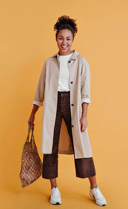 Woman posing coat holding bag