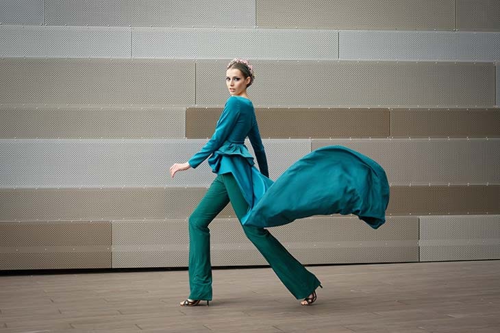 Model wearing turquoise outfit