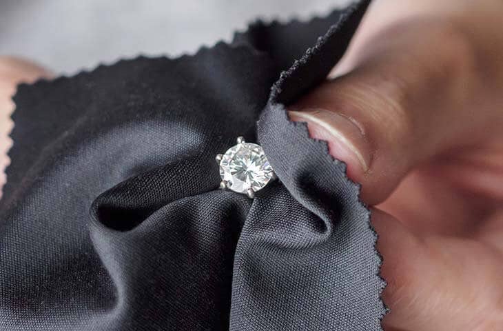 Close up cleaning diamond ring cloth