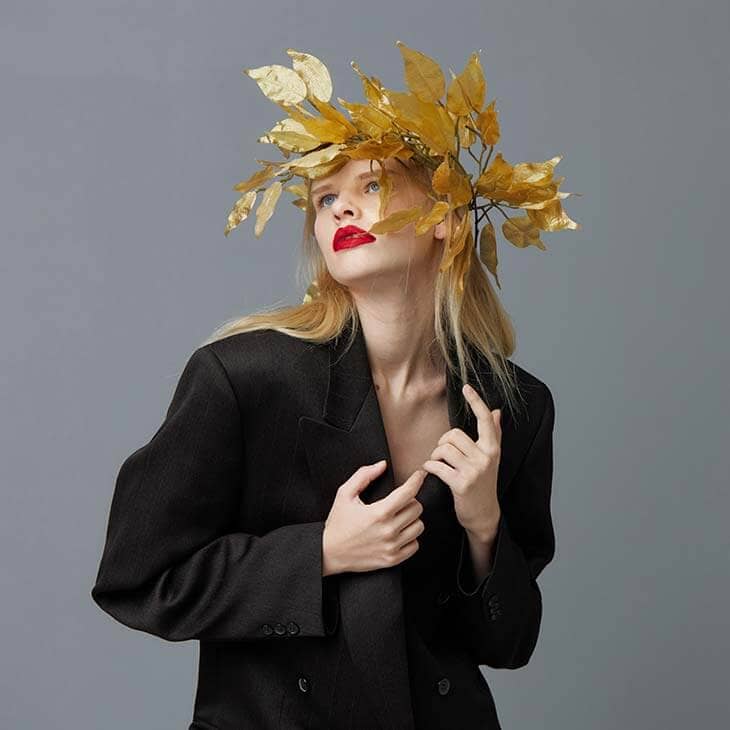 Woman golden leaves black blazer model