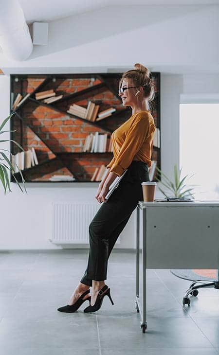 Businesswoman standing near table office