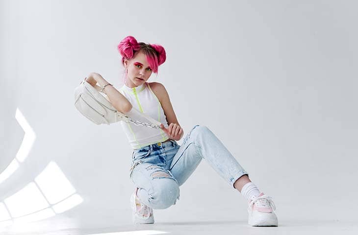Woman posing studio pink hair jeans