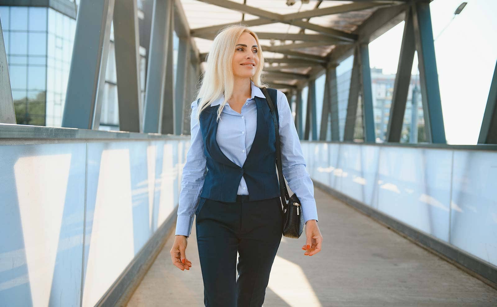 Premium Photo  Beautiful young fashion woman model with sunglasses in  fashionable casual outfit with black coat tshirt hight waist jeans and  sneakers walks near a building on the street urban female