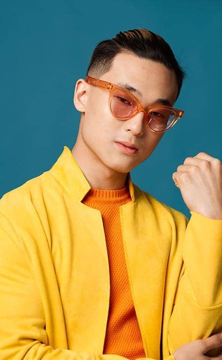 Guy orange glasses yellow jacket