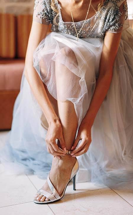 Bride fastens strap sandals