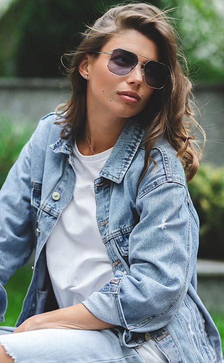 Woman sitting sunglasses jean jacket