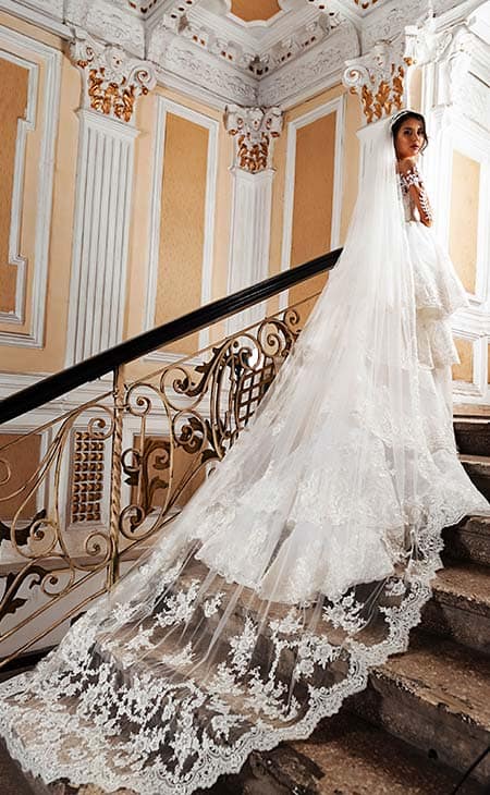 Woman posing stairs wedding dress