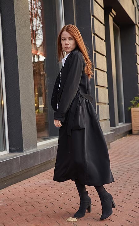 Woman black coat standing outdoors