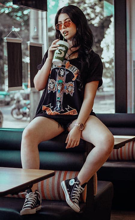 Woman sitting sip drink sunglasses shorts