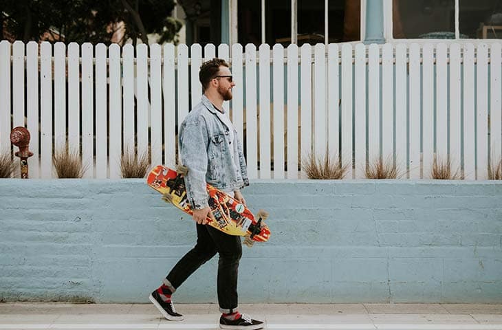 Man walking skateboard street