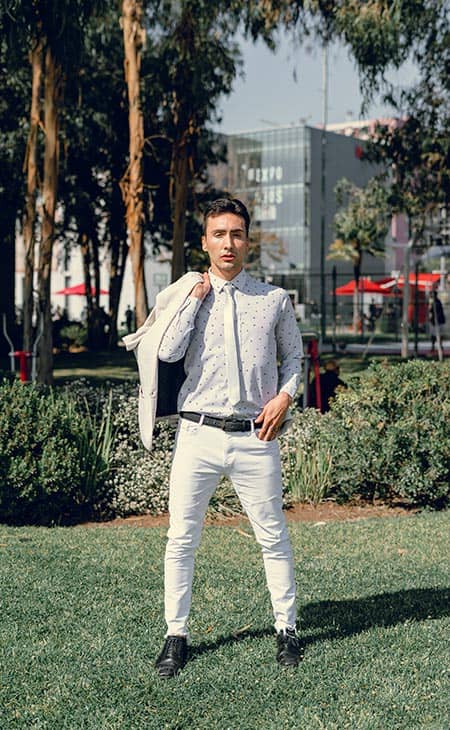 Man posing looking camera white outfit