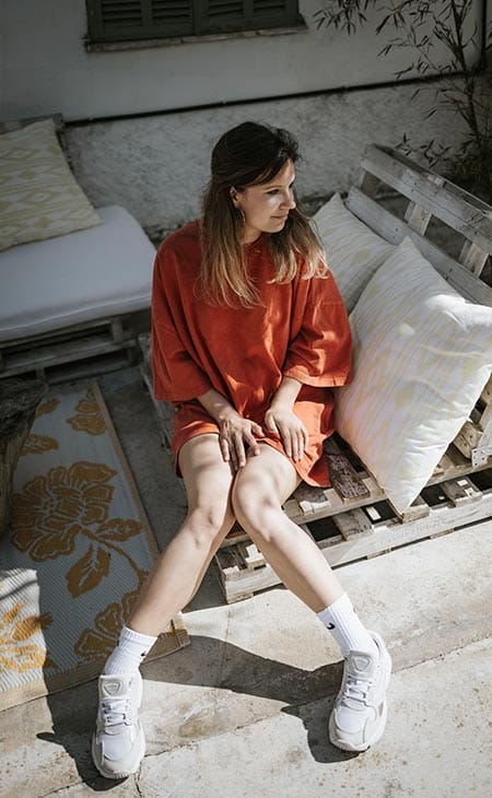 Woman sitting wearing oversized clothes