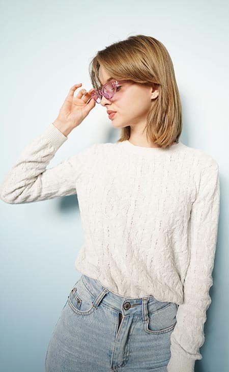 Woman looking side holding glasses