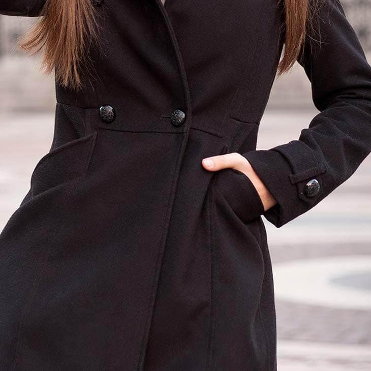 Detail woman hands pocket coat