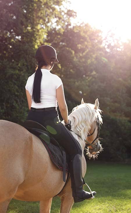 Woman riding horse jodhpurs pants