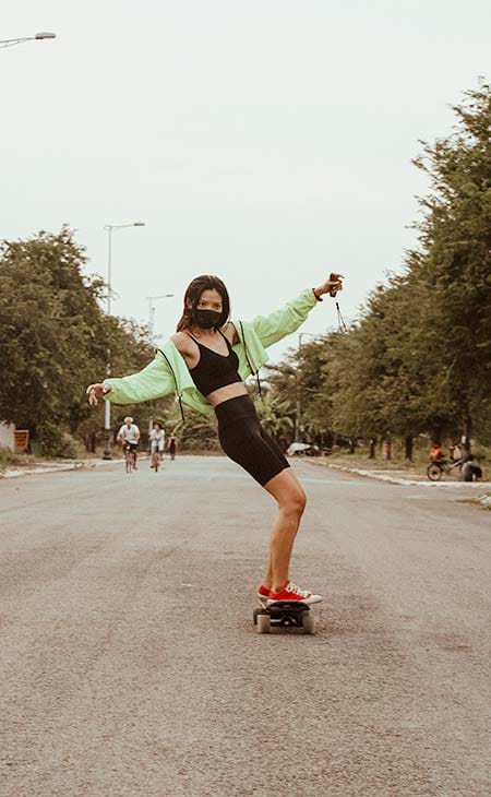 Girl skating road open arms