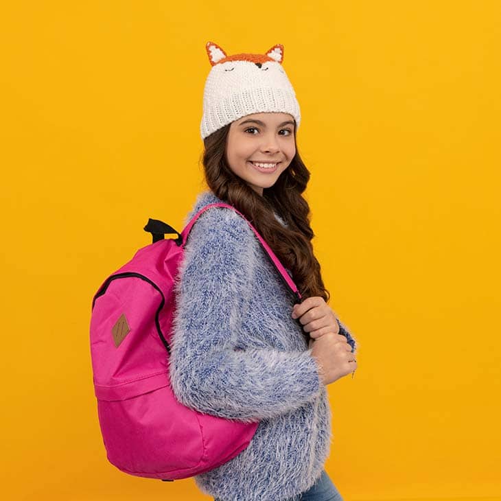 Smiling kid hat school pink backpack