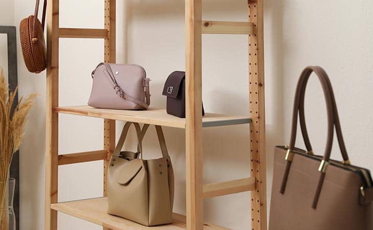 Several purses wooden shelves
