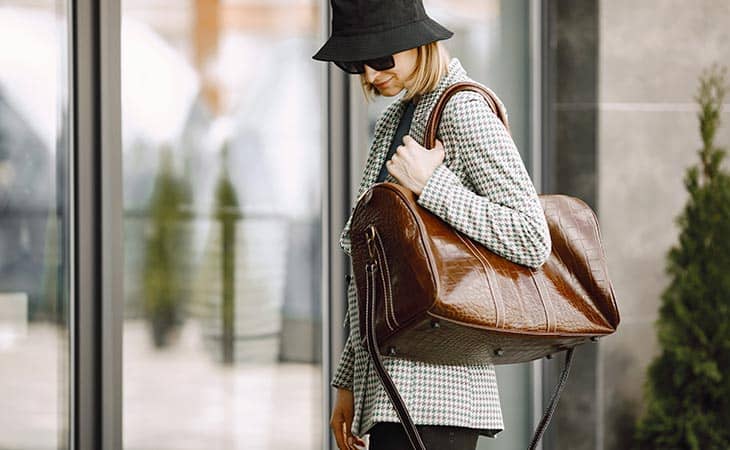 Woman walking brown leather bag