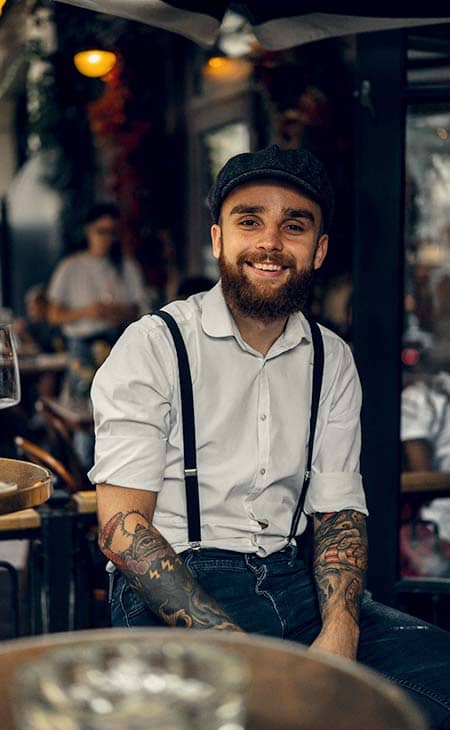 Smiling-man-suspenders-cafe
