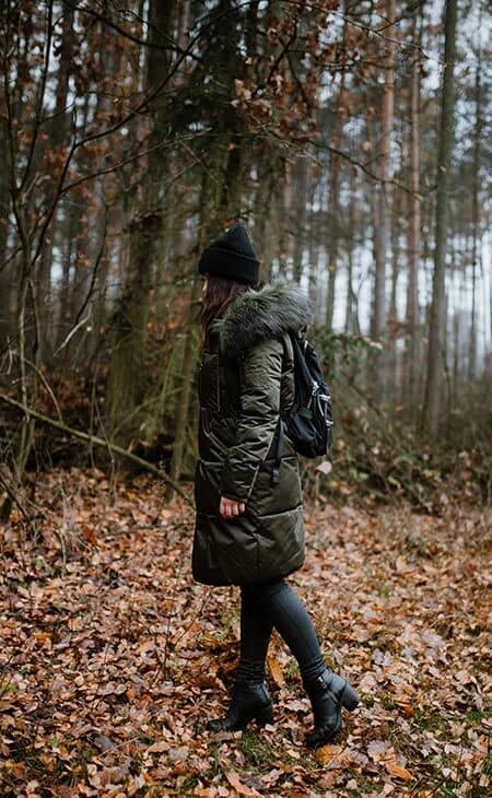 Woman walking woods leafs