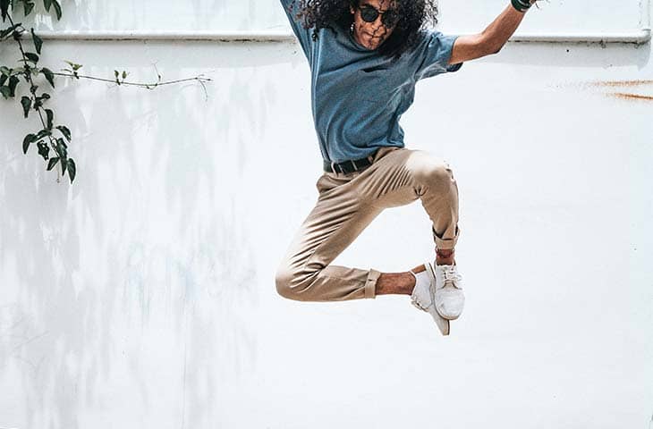 Man jumping outdoor khaki pants