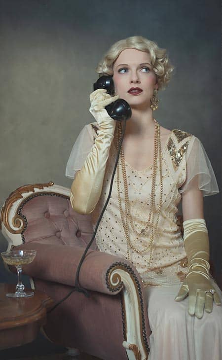 1920s woman calling phone sitting sofa