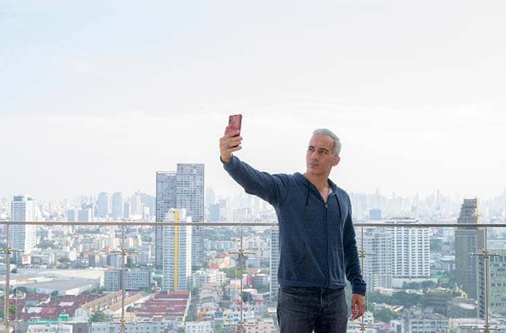 Man taking selfie city landscape