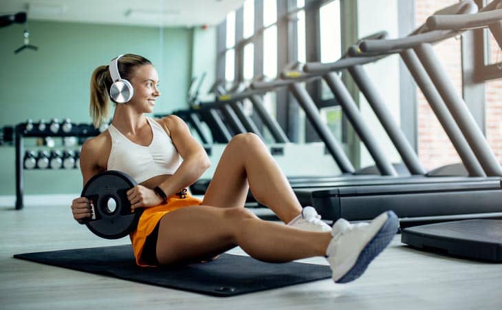 Woman sitting floor wight workout